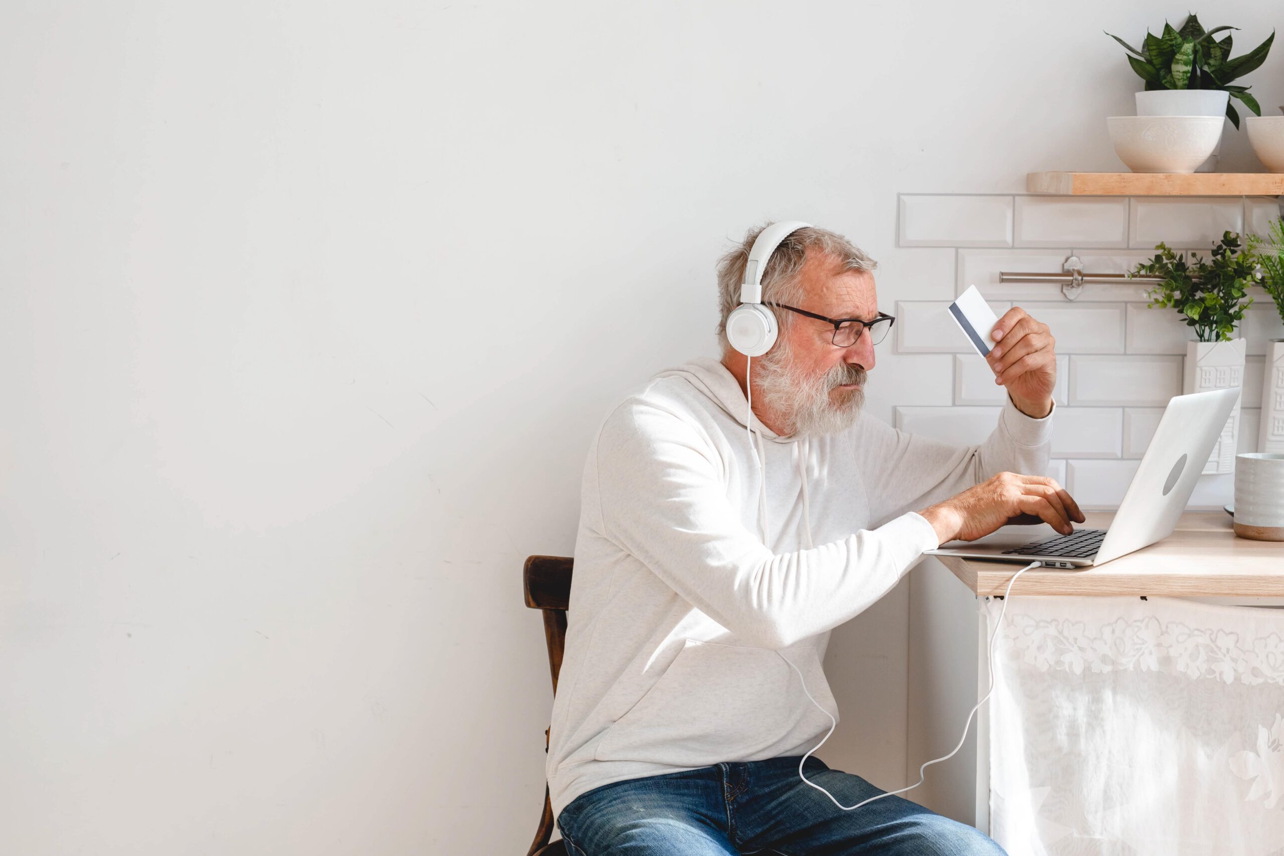 senior-elderly-man-making-online-payments-using-la-2023-11-27-04-52-43-utc-min