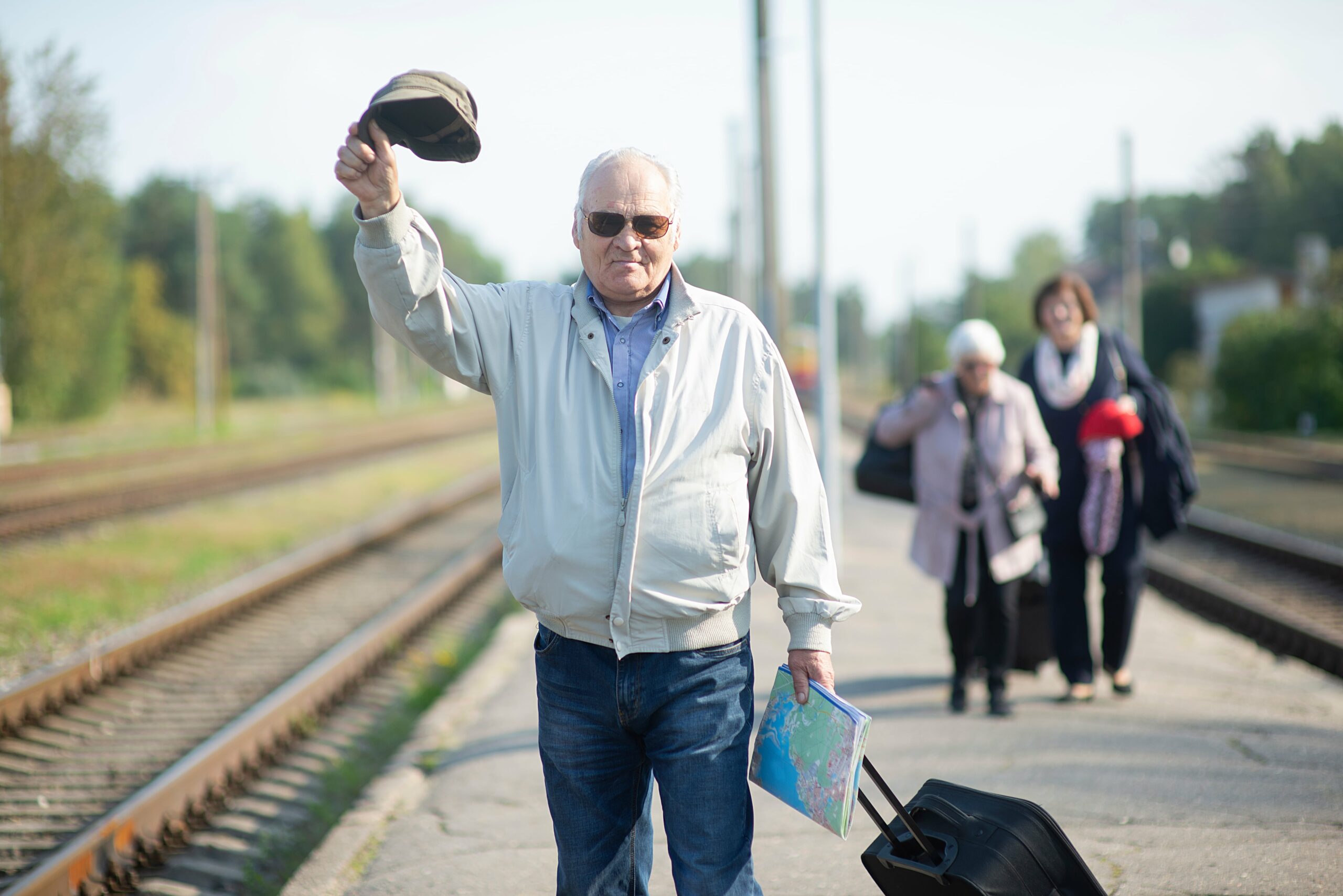 portrait-of-senior-elderly-man-holding-hat-and-map-2023-11-27-04-52-44-utc-min