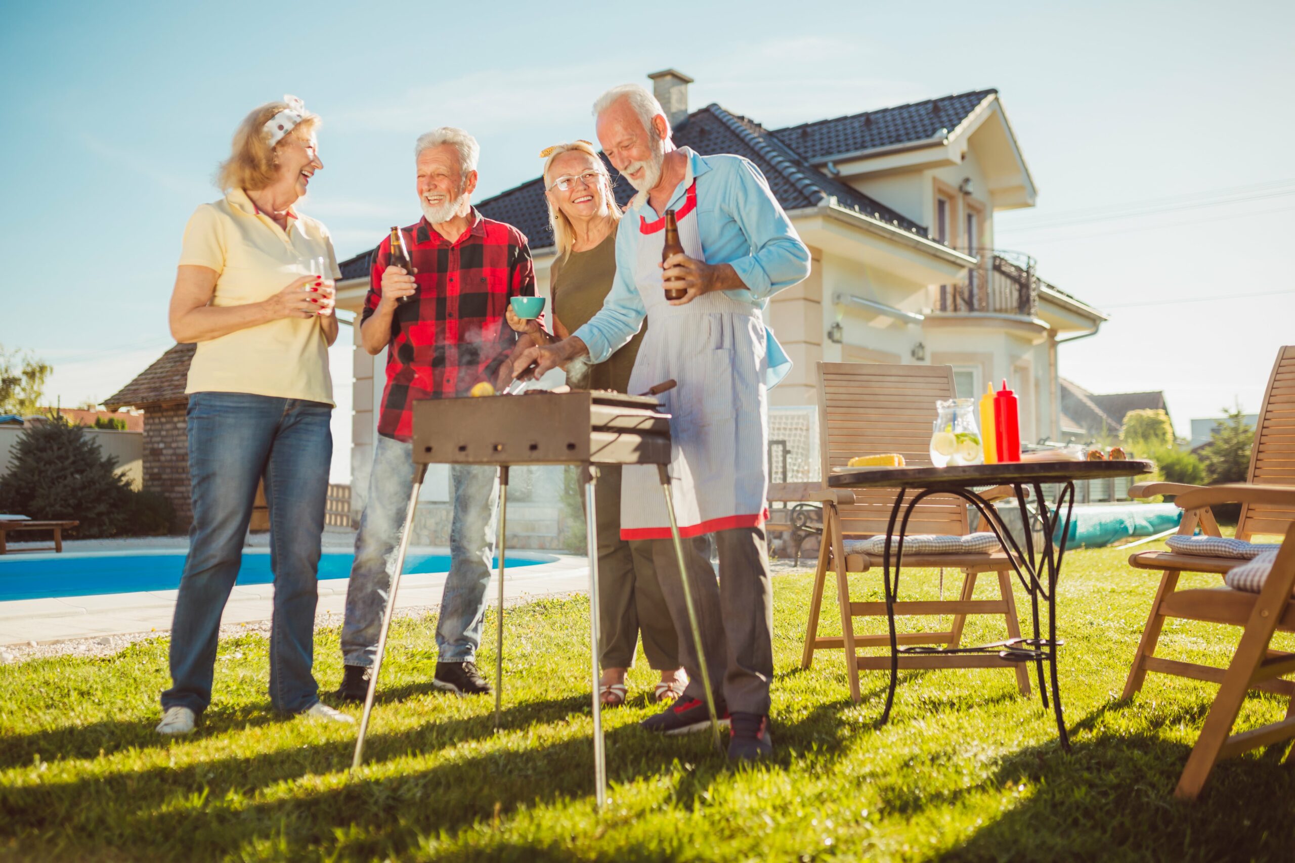 senior-friends-having-backyard-barbecue-party-2023-11-27-05-14-51-utc-min