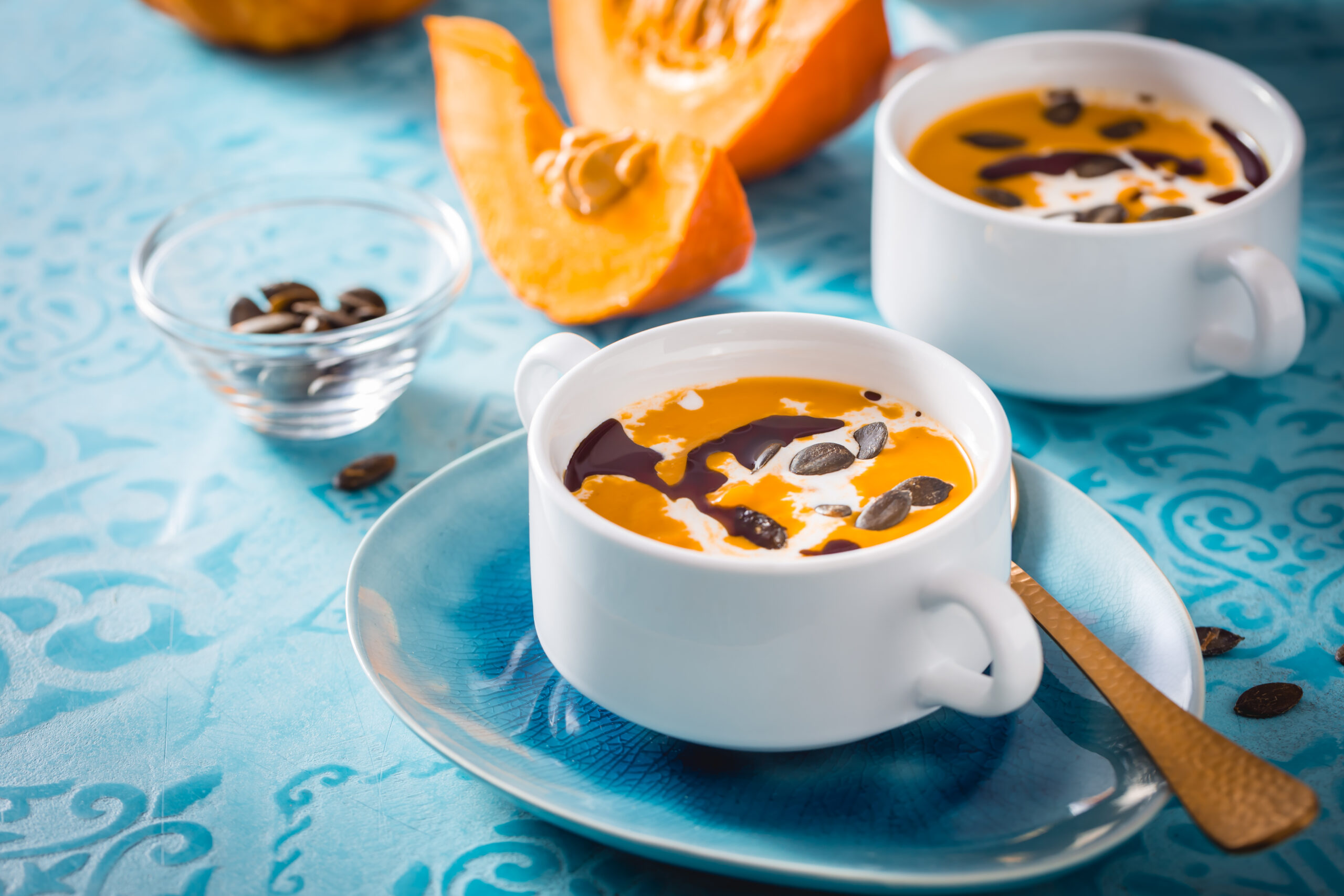 Homemade pumpkin soup with coconut milk, pumpkin oil and seeds